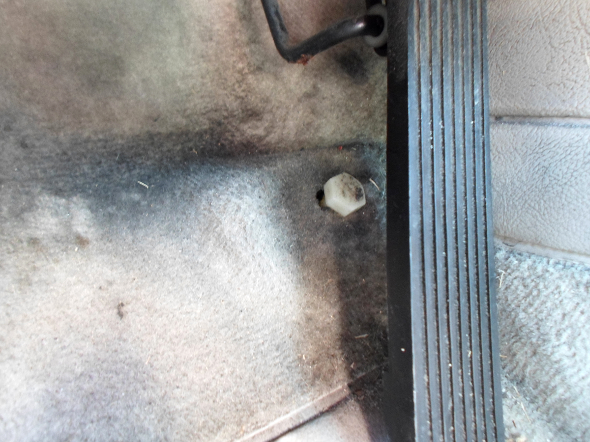 Adjusting stop screw under accelerator pedal